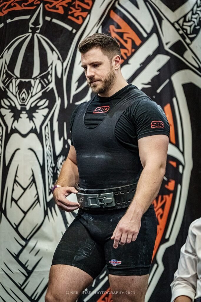 David Stanton getting his belt ready at a powerlifting meet